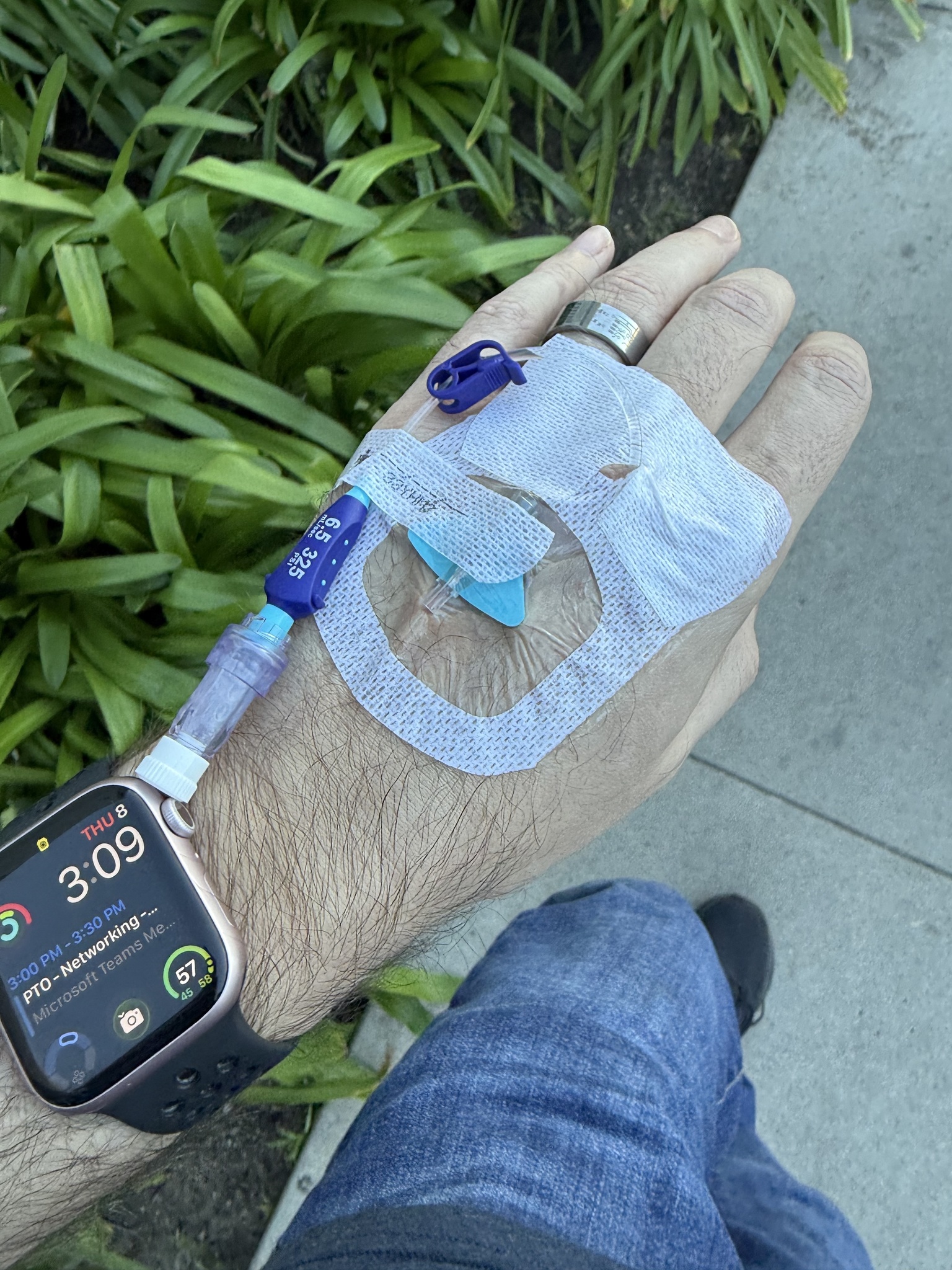 Walking with an IV pole between hospital imaging areas during pneumonia treatment.